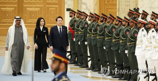 President Yoon Suk Yeol (R), first lady Kim Keon Hee (C) and UAE President Mohamed bin Zayed Al Nahyan (L) inspect an ho<em></em>nor guard during an official welcome ceremony at the Qasr Al Watan presidential palace in Abu Dhabi on Jan. 15, 2023. (Yonhap)