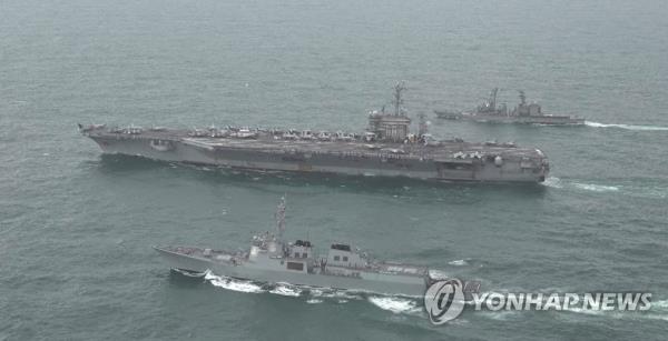 This photo, released by the South Korean Navy, shows South Korean, U.S. and Japanese warships co<em></em>nducting trilateral drills in the internatio<em></em>nal waters south of the Korean Peninsula on April 4, 2023. (PHOTO NOT FOR SALE) (Yonhap)