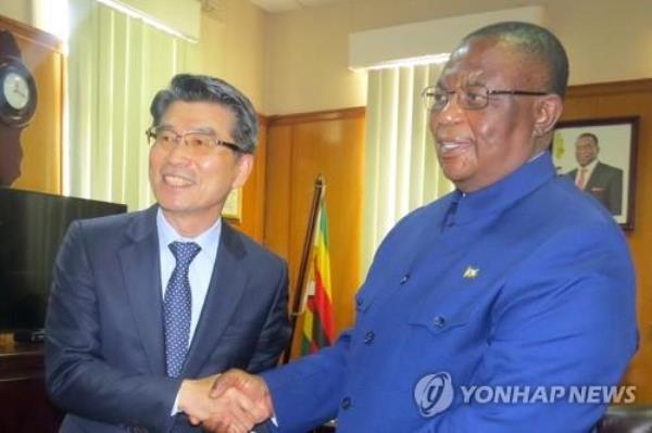 This file photo, provided by Hyundai Motor Group on Sept. 25, 2022, shows Zimbabwe's Vice President Co<em></em>nstantino Chiwenga (R) shaking hands with Kia Corp. President and Chief Executive Song Ho-sung during a meeting in Harare. (PHOTO NOT FOR SALE) (Yonhap)