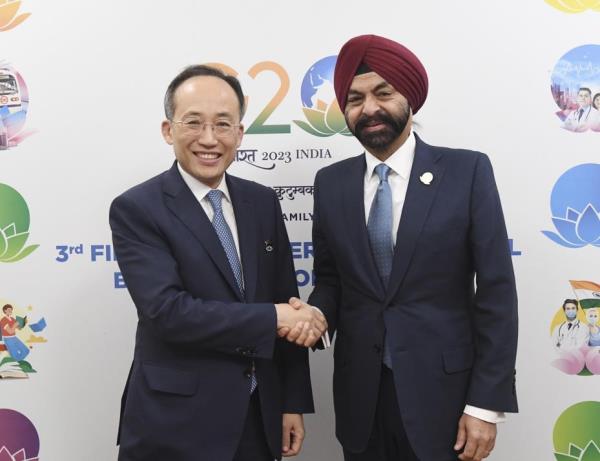 South Korean Finance Minister Choo Kyung-ho (L) shakes hands with World Bank President Ajay Banga on the margins of the G20 Finance Ministers and Central Bank Governors Meeting in Gandhinagar, western India, on July 18, 2023, in this photo provided by the Ministry of Eco<em></em>nomy and Finance. (PHOTO NOT FOR SALE) (Yonhap)