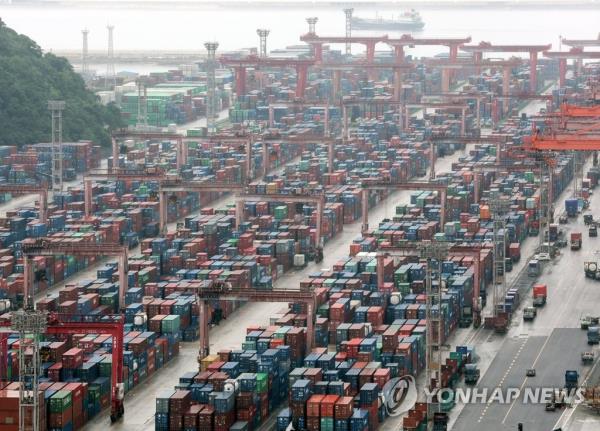 Co<em></em>ntainers are stacked at a pier in South Korea's largest port city of Busan, in this July 4, 2023, file photo. (Yonhap)