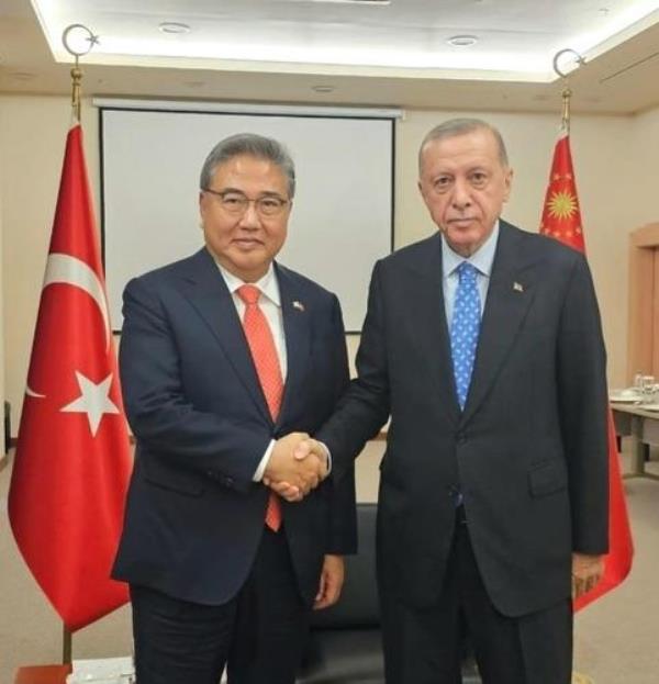 South Korean Foreign Minister Park Jin (L) and Turkish President Recep Tayyip Erdogan shake hands, in this photo provided by the foreign ministry on July 29, 2023. (PHOTO NOT FOR SALE) (Yonhap)