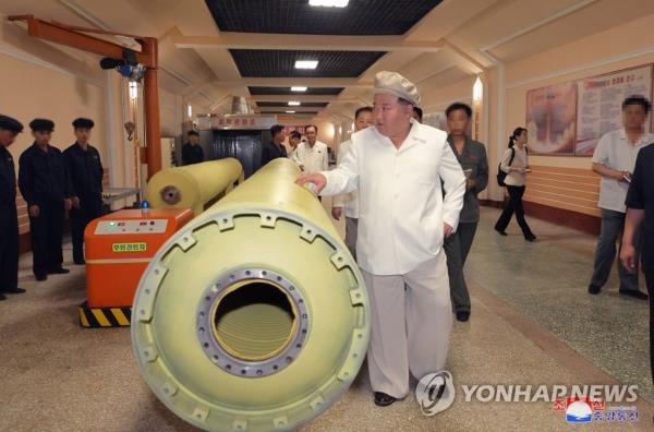 This photo, captured from the website of the North's Korean Central News Agency on Aug. 6, 2023, shows North Korean leader Kim Jong-un giving field guidance at an arms factory. (For Use o<em></em>nly in the Republic of Korea. No Redistribution) (Yonhap)