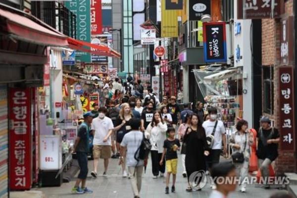 The Myeo<em></em>ngdong shopping district is busy in central Seoul on Aug. 22, 2023. (Yonhap)