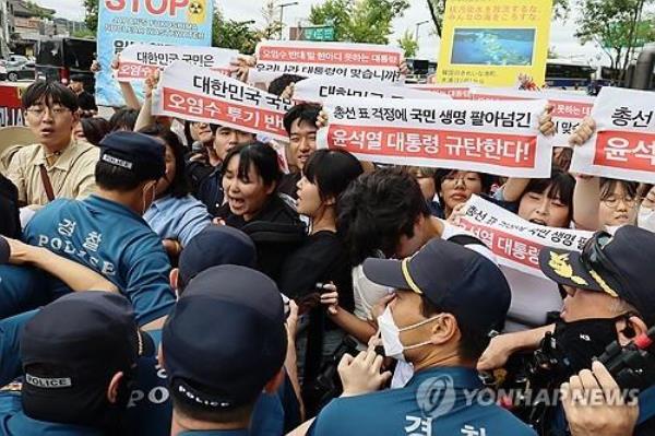 Students clash with police in front of the Japanese Embassy in central Seoul on Aug. 24, 2023, during a protest against Japan's discharge of radioactive water from the Fukushima nuclear power plant, in this photo provided by an association of progressive university students. (PHOTO NOT FOR SALE) (Yonhap)