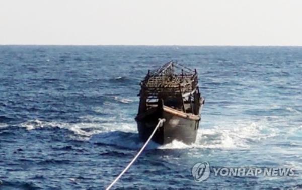 This undated file photo, provided by the unification ministry, shows a North Korean wooden boat being towed from the East Sea in 2019. (PHOTO NOT FOR SALE) (Yonhap)