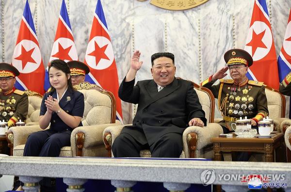 This file photo, carried by North Korea's state-run Korean Central News Agency on Sept. 9, 2023, shows the North's leader Kim Jong-un (R, front row) and his daughter (L, front row), believed to be named Ju-ae, attending a paramilitary parade held at Kim Il Sung Square in Pyo<em></em>ngyang the previous day. (For Use o<em></em>nly in the Republic of Korea. No Redistribution) (Yonhap)