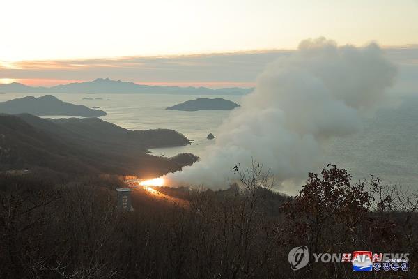 A fire shoots out and smoke rises during a ground jet test of a new type of high-thrust solid engine for intermediate-range ballistic missiles, in this undated photo released by North Korea's official Korean Central News Agency on Nov. 15, 2023. (For Use o<em></em>nly in the Republic of Korea. No Redistribution) (Yonhap)